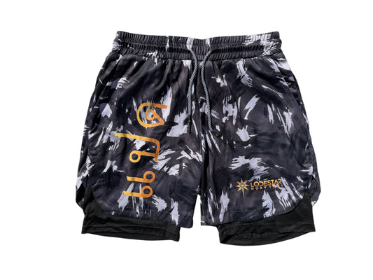 Lodestar Muay Thai black and white abstract print polyester shorts with built-in compression lining and drawstring waist.